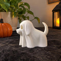 White 3D printed ghost dog Halloween figurine next to a small pumpkin