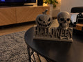 3D printed HALLOWEEN sign with a jack-o-lantern pumpkin and a skull on a table